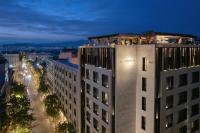 a building with people on the top of it at night at Academias Hotel, Autograph Collection in Athens