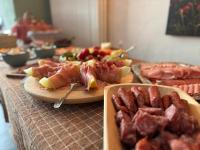 特伦德尔堡Gast- und Pensionshaus Pilgereck的桌子上摆满了肉类和水果。