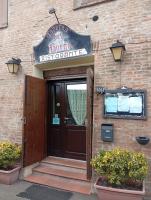 een bakstenen gebouw met een bord boven een deur bij Residenza La Rocca 1227 - Borgo Castello di Serravalle in Castello di Serravalle