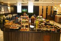 a buffet of food on a table in a lobby at Ramada Encore by Wyndham Chandigarh Zirakpur in Zirakpur