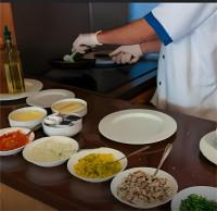 a chef preparing food on a table with plates of food at Star Wars luxury camp in Wadi Rum
