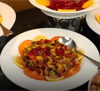 a plate of food on a table with a spoon at Star Wars luxury camp in Wadi Rum