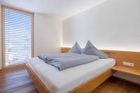 A bed or beds in a room at Krone Apartments Schruns, Top 6/7/8