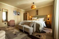a hotel room with a bed and a chair at NH Copenhagen Grand Joanne in Copenhagen