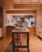 a large kitchen with a table with food on it at NH Copenhagen Grand Joanne in Copenhagen