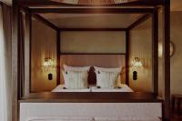 a bedroom with a canopy bed with two pillows at NH Copenhagen Grand Joanne in Copenhagen