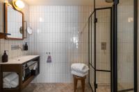 a bathroom with a shower and a sink at NH Copenhagen Grand Joanne in Copenhagen