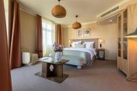 a bedroom with a bed and a table with flowers on it at NH Copenhagen Grand Joanne in Copenhagen