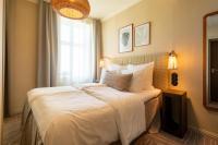 a bedroom with a large white bed with a window at NH Copenhagen Grand Joanne in Copenhagen