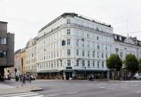a large white building on the corner of a street at NH Copenhagen Grand Joanne in Copenhagen