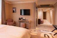 a hotel room with a bed and a television at NH Copenhagen Grand Joanne in Copenhagen
