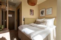 a bedroom with a large white bed in it at NH Copenhagen Grand Joanne in Copenhagen