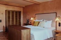 a bedroom with a large bed and two lamps at NH Copenhagen Grand Joanne in Copenhagen