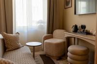a hotel room with a chair and a table at NH Copenhagen Grand Joanne in Copenhagen