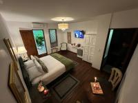 a bedroom with a bed and a living room at Leclerc Hotel Boutique Cali Granada in Cali