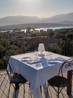 a table with a blue table cloth and chairs on a balcony at Le San Lorenzo in Porto-Vecchio