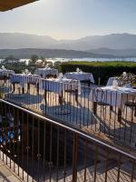 a restaurant with tables and chairs on a balcony at Le San Lorenzo in Porto-Vecchio