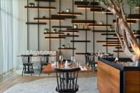 a restaurant with tables and chairs in a room at SLS Playa Mujeres - ALL Inclusive Collection in Cancún