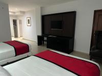 Postel nebo postele na pokoji v ubytování Ramada by Wyndham Princess Santo Domingo