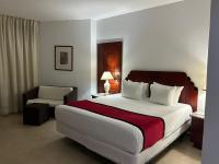Postel nebo postele na pokoji v ubytování Ramada by Wyndham Princess Santo Domingo