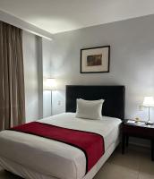 Postel nebo postele na pokoji v ubytování Ramada by Wyndham Princess Santo Domingo