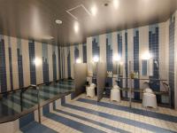 a bathroom with two toilets and a swimming pool at Green Rich Hotel Nagoya Nishiki (Artificial hot spring Futamata Yunohana) in Nagoya