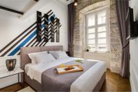 Postel nebo postele na pokoji v ubytování DeZign Superior Apartments & Rooms