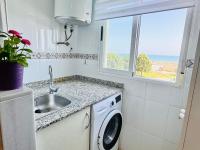 A kitchen or kitchenette at .Apartamento 1a linea de playa + piscina + parking DAIMUS