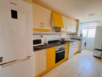 A kitchen or kitchenette at .Apartamento 1a linea de playa + piscina + parking DAIMUS