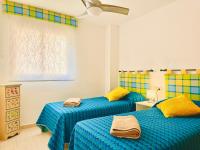 A bed or beds in a room at .Apartamento 1a linea de playa + piscina + parking DAIMUS