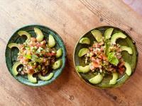 two green bowls of food on a wooden table at Riad Eucalyptus, hôtel de charme Essaouira in Essaouira