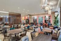 a restaurant with tables and chairs and a lobby at Hampton By Hilton Venice Isola Nuova in Venice