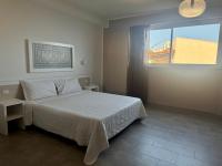 A bed or beds in a room at Castelsardo Resort Village