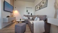 Televízia a/alebo spoločenská miestnosť v ubytovaní Apartmani Marini