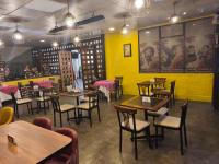 een restaurant met tafels en stoelen en een gele muur bij Waalay Hotel in Huancayo