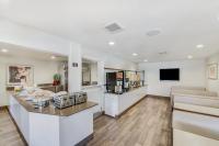 a living room with a counter and a tv at Anaheim Desert Inn & Suites in Anaheim