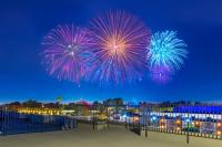 a firework display in the sky over a city at Anaheim Desert Inn & Suites in Anaheim