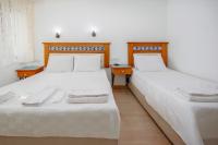 Postel nebo postele na pokoji v ubytování Datca Kilic Hotel