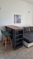 einen Schreibtisch mit einem Stuhl neben einer Couch in der Unterkunft Montebello Inn apartments in Ulcinj