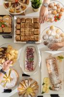 un tavolo pieno di diversi tipi di cibo su piatti di Hotel Lux a Gabicce Mare