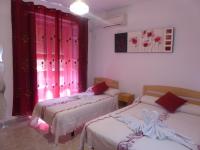 A bed or beds in a room at Hostal Huespedes Toledo