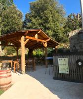 a wooden pergola with a table and chairs at A Chjusella di E Sertine in Tralonca