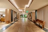 Un pasillo vacío de un hotel con un banco. en Sheraton Bariloche Hotel, en San Carlos de Bariloche