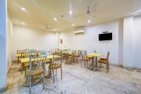 a conference room with tables and chairs and a tv at Hotel Happy Stay Delhi Airport in New Delhi