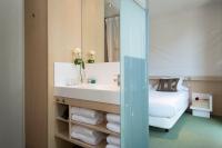 A bed or beds in a room at Ako Suite Hotel