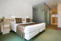 A bed or beds in a room at Ako Suite Hotel