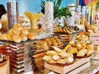a buffet with different types of bread and pastries at SOLAYAstay in Gò Ba Quần