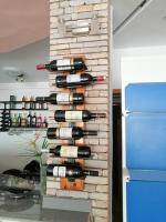 una pila di bottiglie di vino su un muro di OLA LUXURY HOTEL Parakou a Parakou