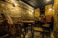 a bar with chairs and tables and a brick wall at The Brewers Inn in London
