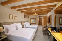 A bed or beds in a room at La Boutique Maya